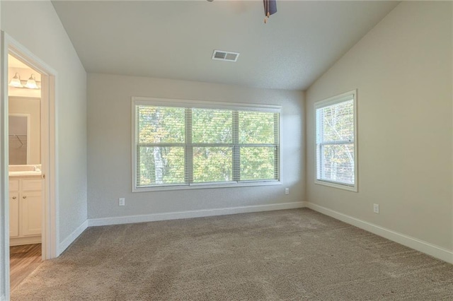392 Dublin Way, Dallas, GA 30132 - carpeted empty room with visible vents, ceiling fan, vaulted ceiling, and baseboards