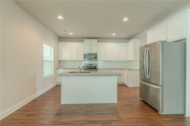 392 Dublin Way, Dallas, GA 30132 - kitchen featuring light stone countertops, white cabinets, stainless steel appliances, and decorative backsplash