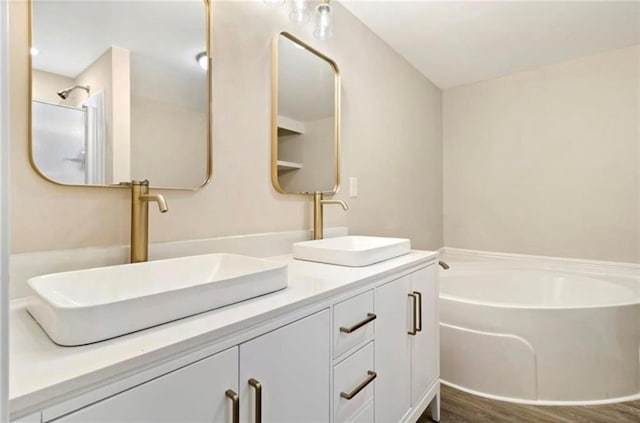 67 Gatewood Rd, Ellijay, GA 30540 - full bath with double vanity, a garden tub, and wood finished floors