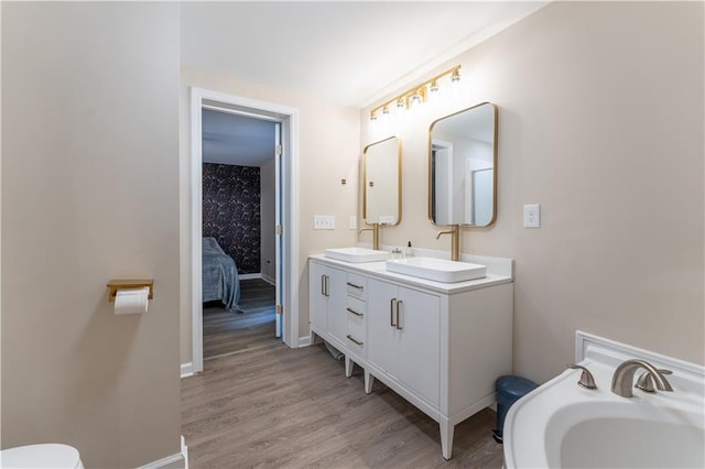 67 Gatewood Rd, Ellijay, GA 30540 - bathroom with wood finished floors, double vanity, baseboards, toilet, and ensuite bath
