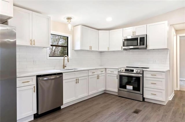 67 Gatewood Rd, Ellijay, GA 30540 - kitchen with stainless steel appliances, white cabinetry, light countertops, wood finished floors, and a sink