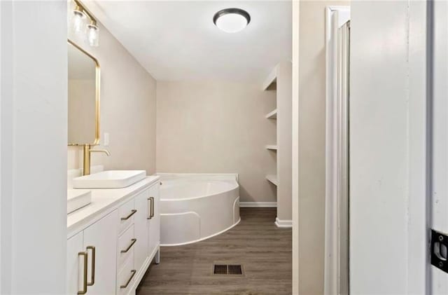 67 Gatewood Rd, Ellijay, GA 30540 - bathroom with double vanity, a bath, and wood finished floors
