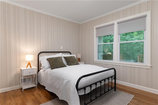 bedroom featuring wood-type flooring and ornamental molding