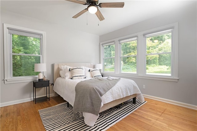 bedroom with light hardwood / wood-style floors and ceiling fan