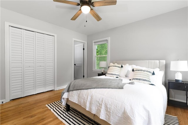 bedroom featuring ceiling fan, a closet, and light hardwood / wood-style flooring