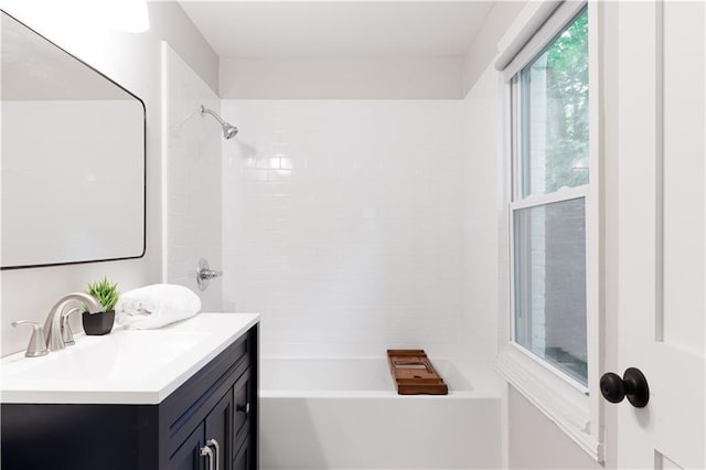 bathroom featuring vanity and tiled shower / bath