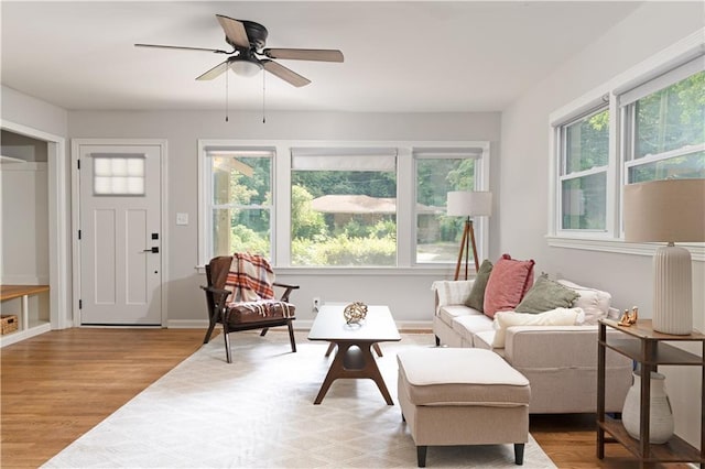 living area with light hardwood / wood-style flooring and ceiling fan