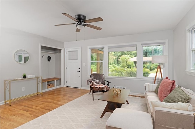 living room with light wood-type flooring and ceiling fan