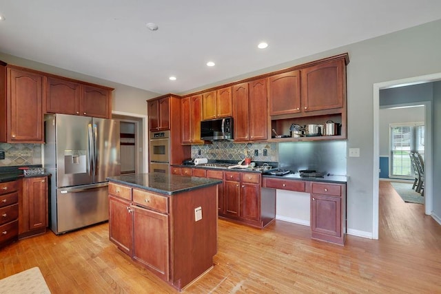 1663 Willow Way, Woodstock, GA 30188 - kitchen with stainless steel appliances, light wood-style floors, a center island, backsplash, and recessed lighting