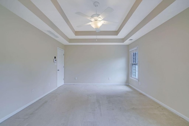 1663 Willow Way, Woodstock, GA 30188 - spare room with a tray ceiling, light carpet, and baseboards