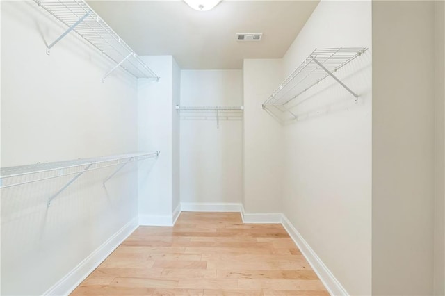 walk in closet with visible vents and light wood-style floors