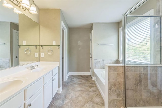 full bathroom featuring a garden tub, baseboards, a sink, and double vanity