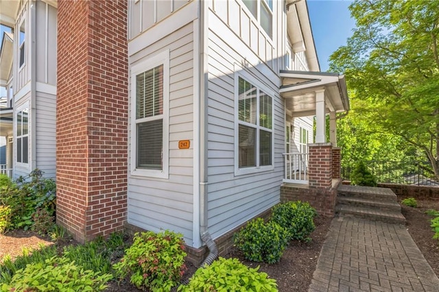 view of property exterior with brick siding and board and batten siding