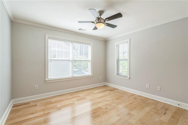 spare room featuring baseboards, light wood-style floors, and crown molding