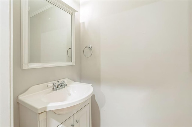 bathroom featuring crown molding and vanity