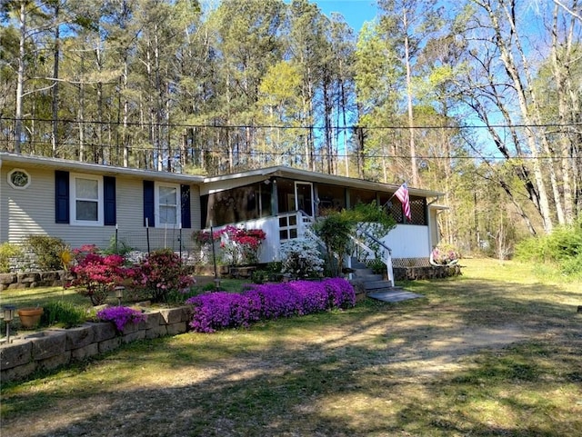 ranch-style home featuring a front yard