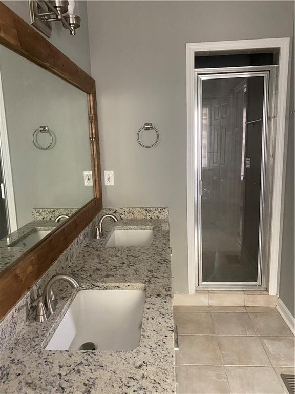 bathroom with tile patterned flooring and vanity