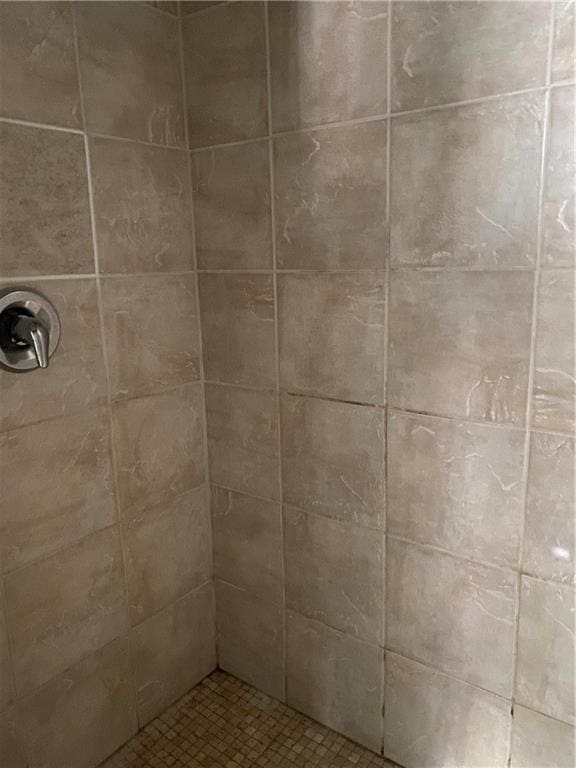 bathroom with a tile shower