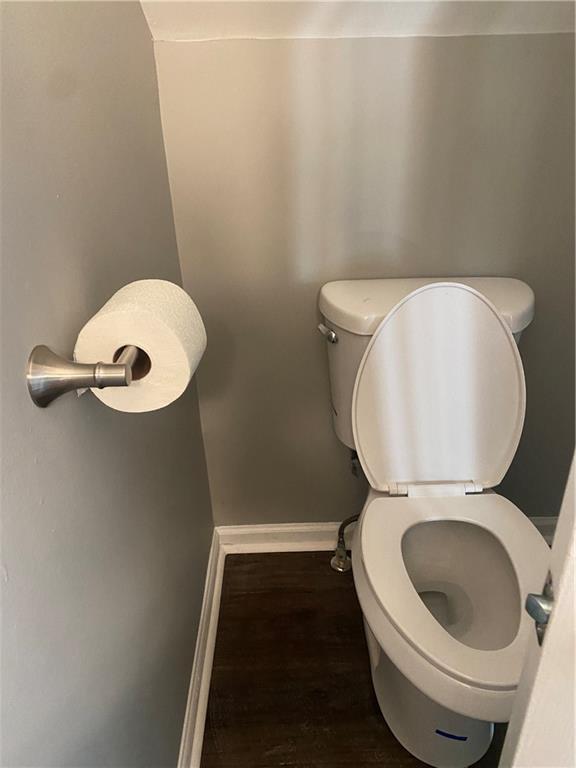 bathroom with hardwood / wood-style floors and toilet