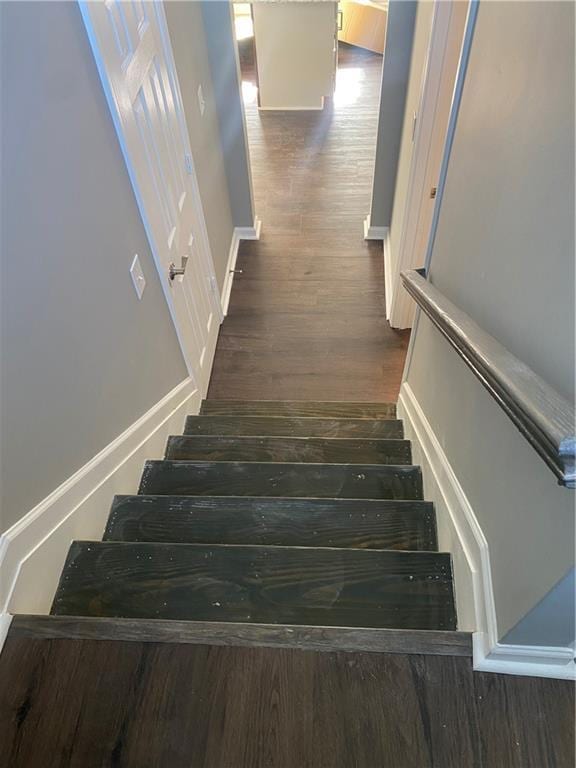 staircase with wood-type flooring