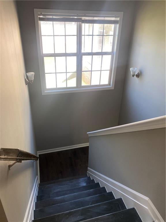 stairs featuring hardwood / wood-style flooring