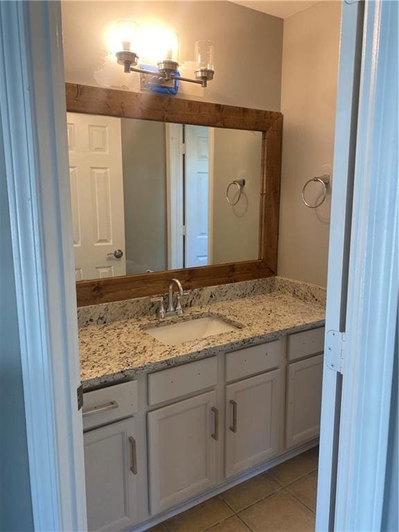 bathroom with tile patterned flooring and vanity