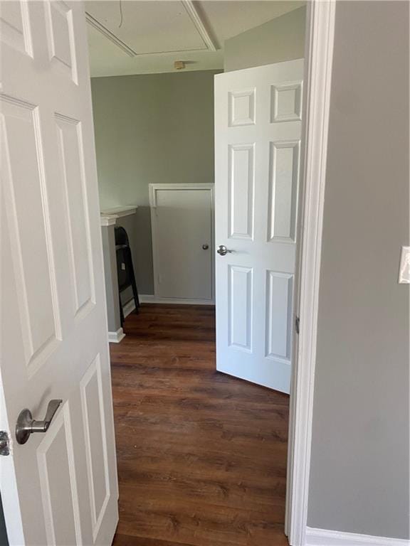 laundry area with dark hardwood / wood-style flooring