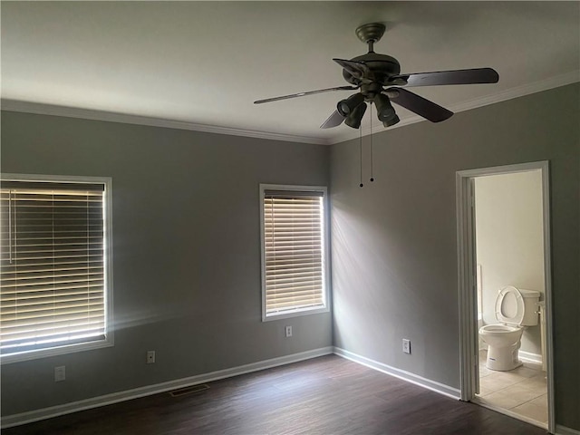 unfurnished room featuring dark hardwood / wood-style flooring, ceiling fan, and ornamental molding