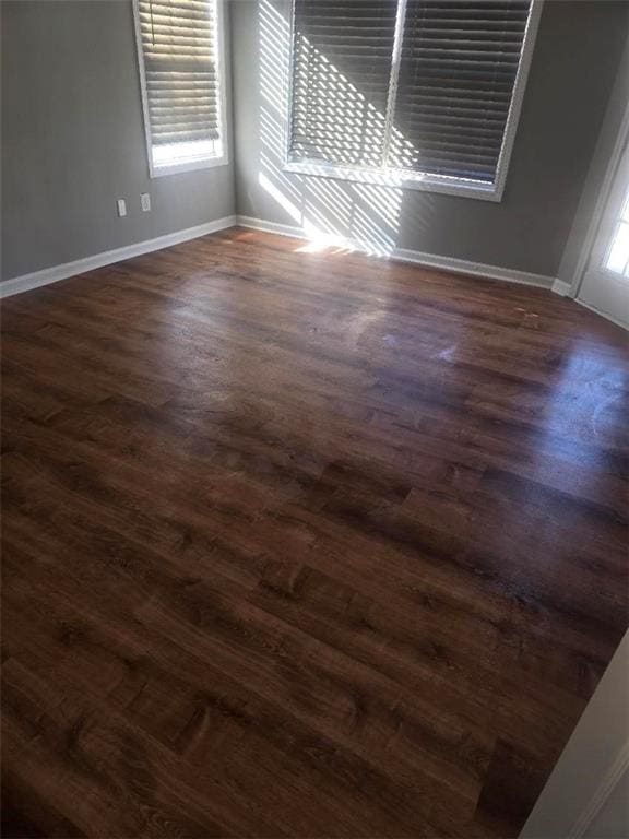 spare room with dark wood-type flooring