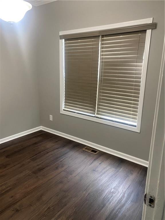 spare room featuring dark wood-type flooring