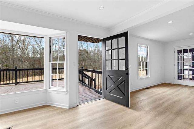 entryway featuring baseboards, ornamental molding, wood finished floors, and recessed lighting