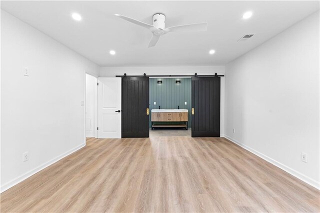 bathroom featuring double vanity, tile patterned flooring, a tile shower, and a sink