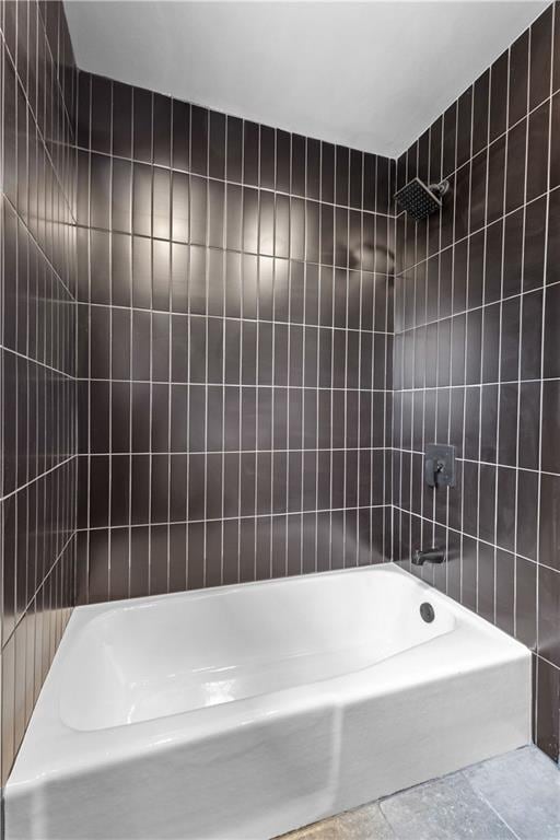 full bath with shower / bath combination and tile walls