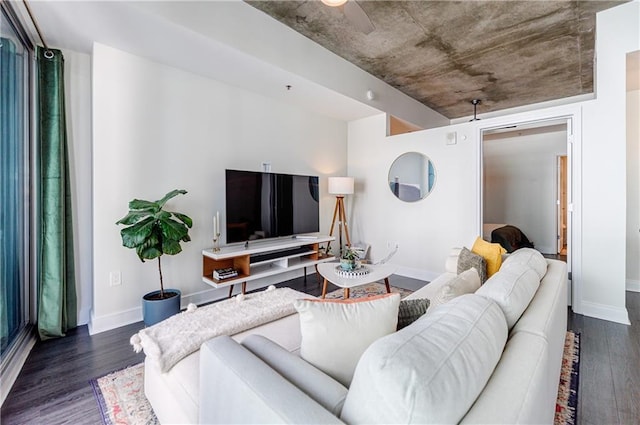 living area featuring dark wood-type flooring and baseboards