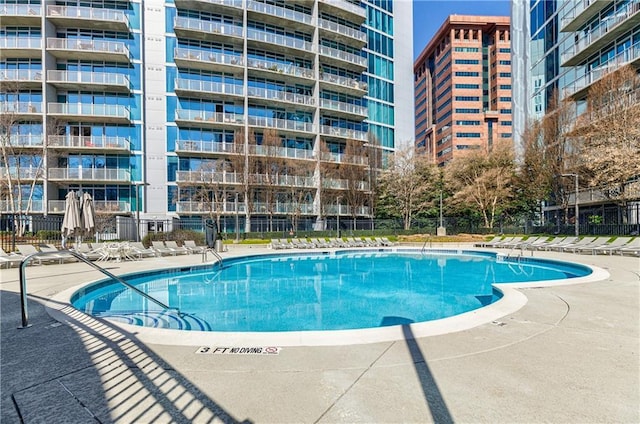 view of pool featuring fence