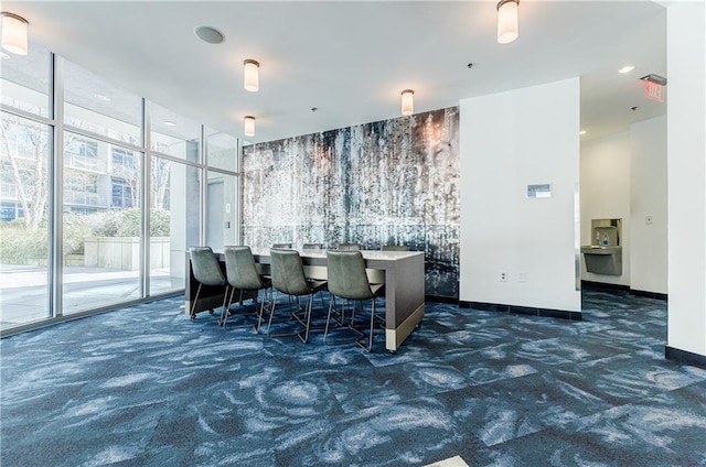 dining room featuring carpet floors, expansive windows, baseboards, and recessed lighting