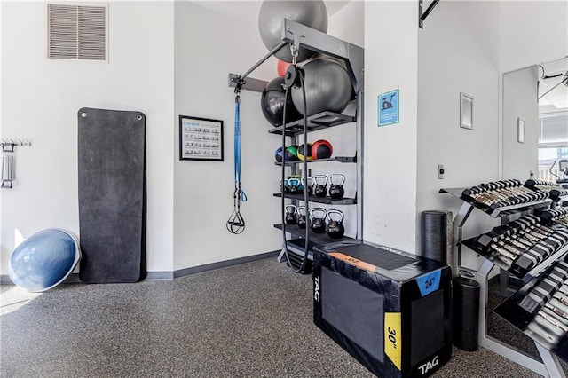 workout room featuring baseboards and visible vents