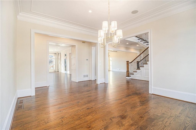 unfurnished dining area with dark wood-type flooring, an inviting chandelier, and ornamental molding