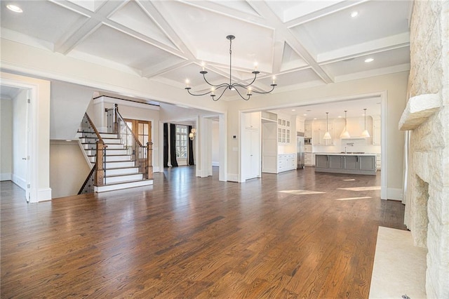 unfurnished living room with beamed ceiling, dark hardwood / wood-style floors, and coffered ceiling