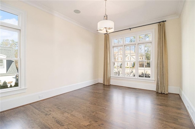 empty room featuring dark wood-type flooring and ornamental molding