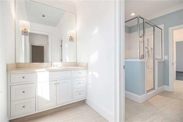 bathroom with vanity, walk in shower, and crown molding