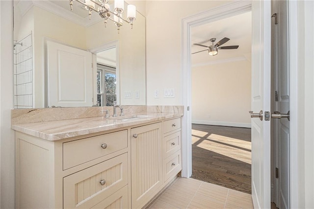 bathroom featuring tile patterned floors, ceiling fan with notable chandelier, ornamental molding, and vanity