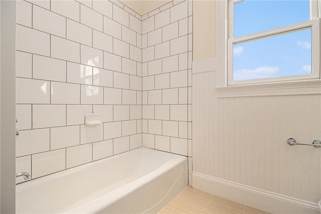 bathroom with tile patterned floors and tiled shower / bath combo