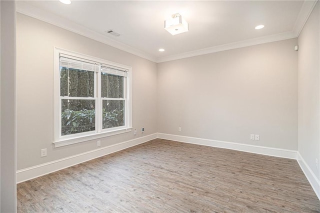 unfurnished room with hardwood / wood-style floors and crown molding