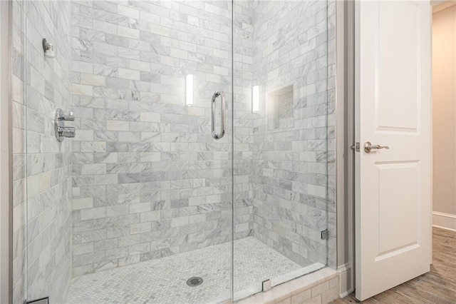 bathroom with wood-type flooring and walk in shower