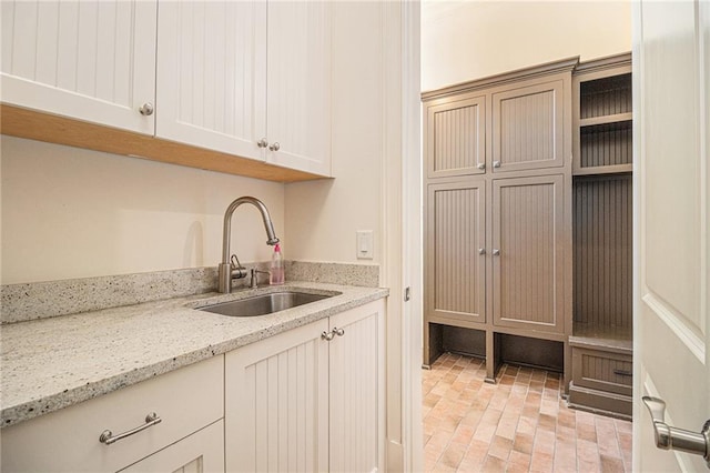 kitchen with light stone countertops and sink