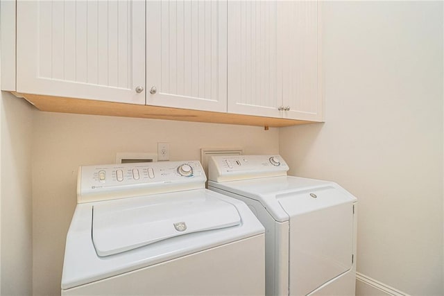 laundry room featuring cabinets and separate washer and dryer