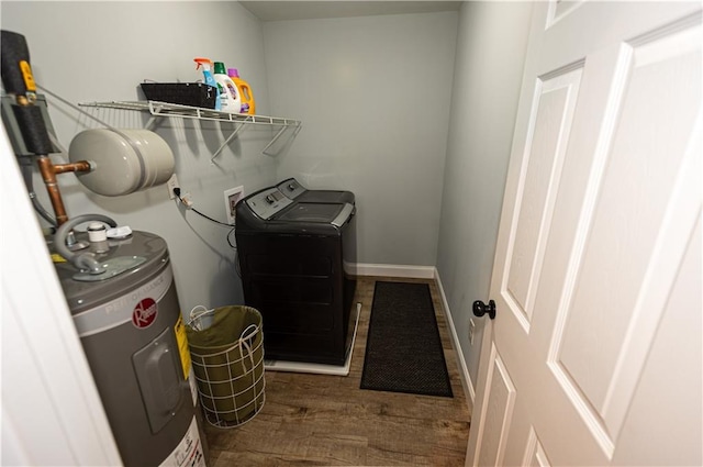 laundry area with laundry area, wood finished floors, baseboards, electric water heater, and separate washer and dryer