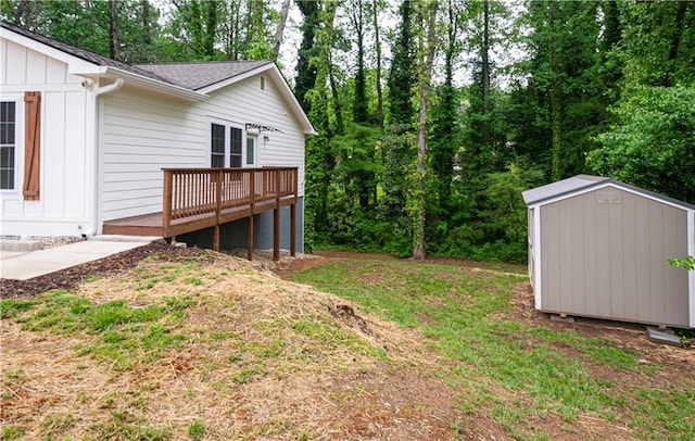 view of yard with a storage shed, a deck, and an outbuilding