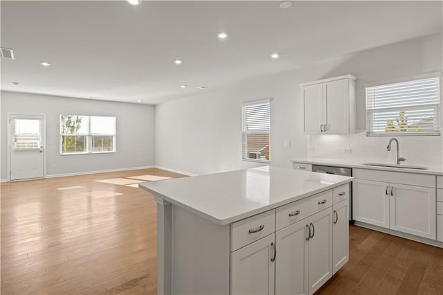 488 Village Ln, Fairburn, GA 30213 - kitchen with a sink, light wood-style flooring, decorative backsplash, plenty of natural light, and recessed lighting